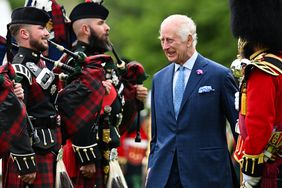 Britain's King Charles III inspects a guard of honour formed by members of The Band of the Royal Regiment of Scotland during the Ceremony of the Keys at the Palace of Holyroodhouse in Edinburgh on July 2, 2024.