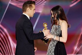 Colin Farrell accepts the Best Actor in a Motion Picture – Musical or Comedy award for "The Banshees of Inisherin" from Ana de Armas onstage at the 80th Annual Golden Globe Awards held at the Beverly Hilton Hotel on January 10, 2023 in Beverly Hills, California.