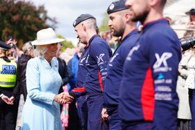 Queen Camilla meets members of the parachute display team during day four of the Sky Bet Ebor Festival at York Racecourse. Picture date: Saturday August 24, 2024.