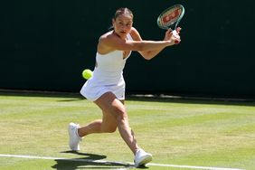 Marta Kostyuk of Ukraine plays a backhand against Daria Saville of Australia in her Ladies' Singles second round match during day four of The Championships Wimbledon 2024 at All England Lawn Tennis and Croquet Club on July 04, 2024 in London, England.