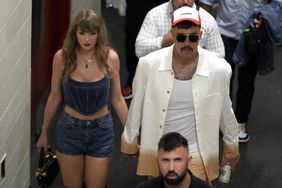 Kansas City Chiefs tight end Travis Kelce, right, and Taylor Swift hold hands following an NFL football game between the Chiefs and the Baltimore Ravens 