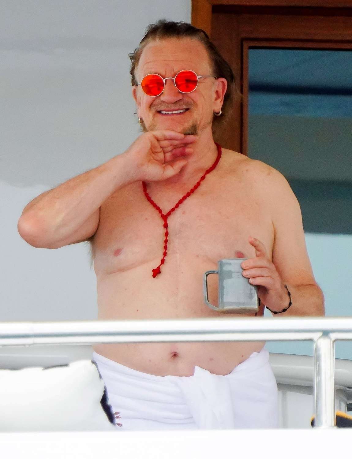 U2 Singer Bono pictured showing off his impressive physique while enjoying his coffee onboard his mega yacht in St Tropez.