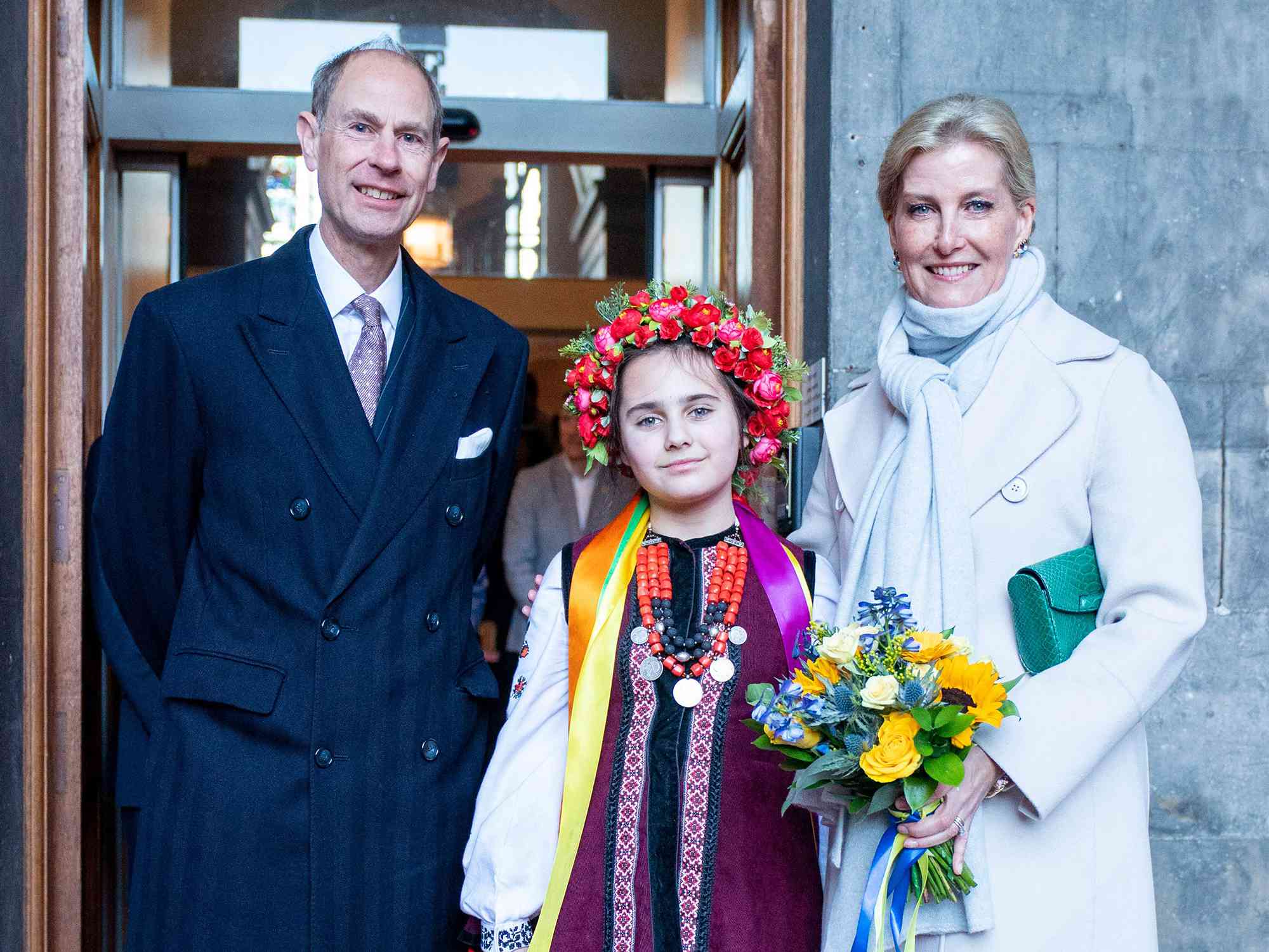 Britain's Prince Edward, Duke of Edinburgh (L) and Britain's Sophie, Duchess of Edinburgh (R) pose for a photograph with Marianna Melnyk, aged 10, from the Ukrainian community at the City Chambers in Edinburgh