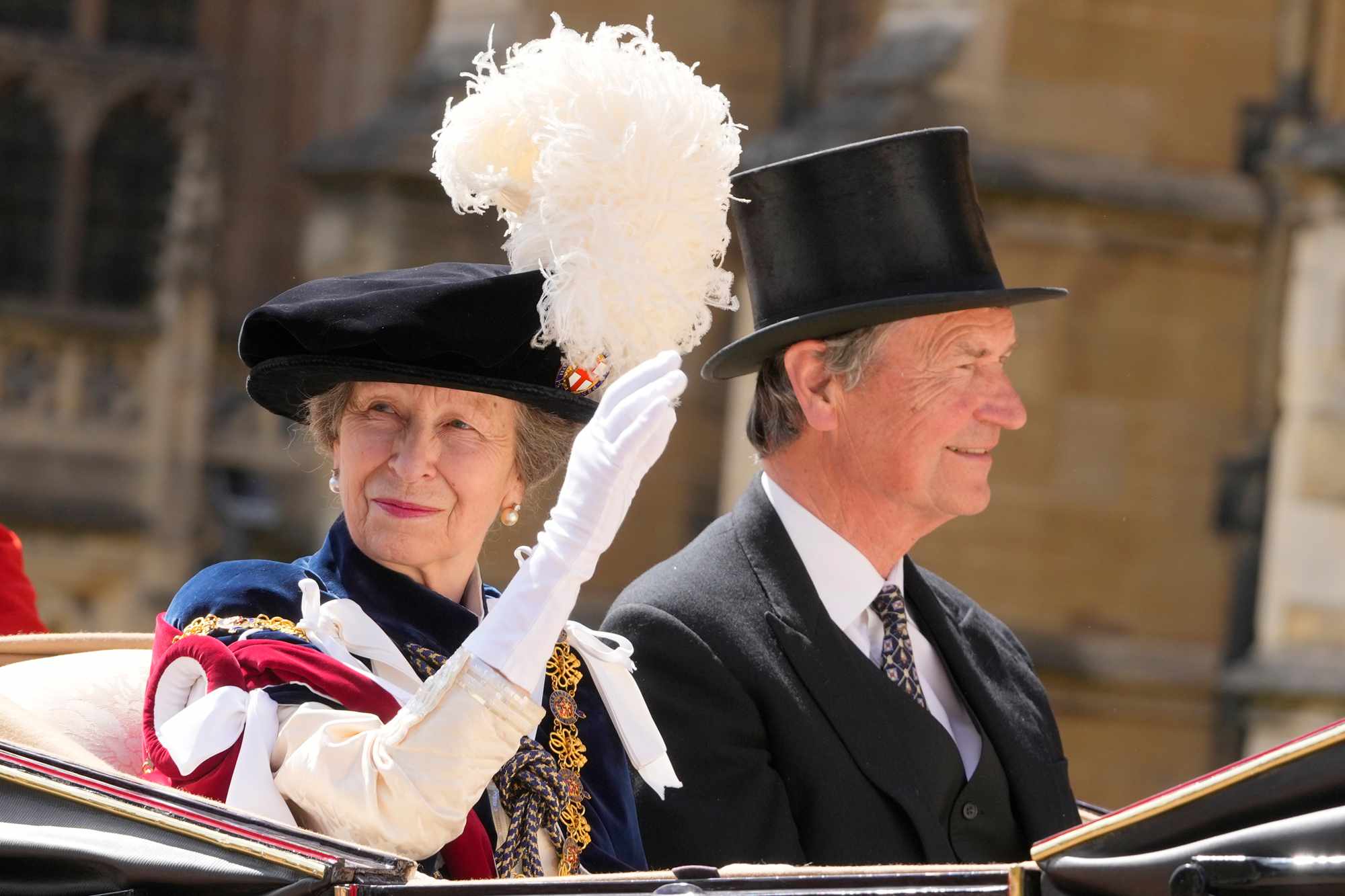 Princess Anne and her husband Timothy Lawrence ride in a carriage after attending the Order of the Garter service at Windsor Castle on June 17, 2024 in Windsor, England. 