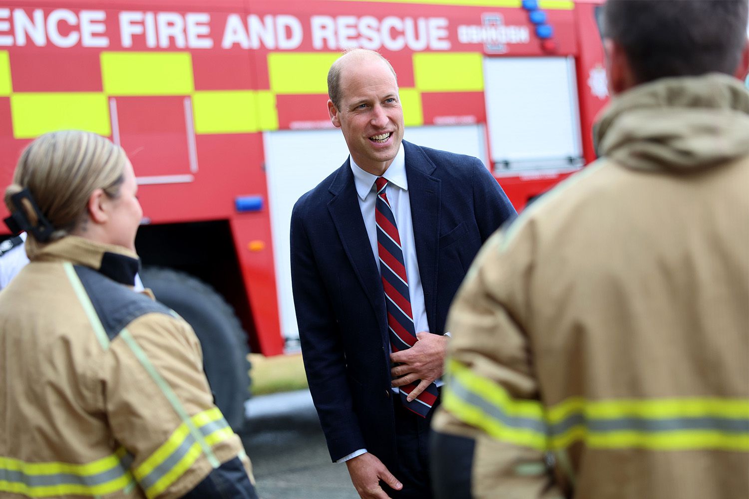Prince William, Prince of Wales talks to base personnel after a simulated fire response exercise during an official visit at RAF Valley on July 09, 2024 in Holyhead, United Kingdom.