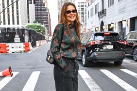 katie holmes in floral blouse walking across the street in new york