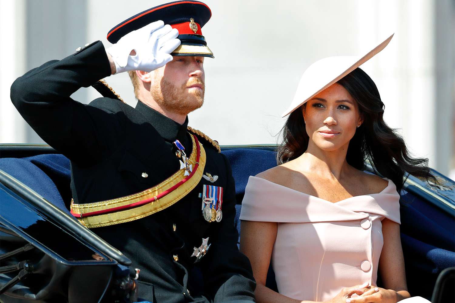 LONDON, UNITED KINGDOM - JUNE 09: (EMBARGOED FOR PUBLICATION IN UK NEWSPAPERS UNTIL 24 HOURS AFTER CREATE DATE AND TIME) Prince Harry, Duke of Sussex and Meghan, Duchess of Sussex travel down The Mall in a horse drawn carriage during Trooping The Colour 2018 on June 9, 2018 in London, England. The annual ceremony involving over 1400 guardsmen and cavalry, is believed to have first been performed during the reign of King Charles II. The parade marks the official birthday of the Sovereign, even though the Queen's actual birthday is on April 21st. (Photo by Max Mumby/Indigo/Getty Images)