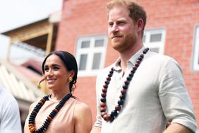 Duke of Sussex Prince Harry (R) his wife Meghan Markle (L), Duchess of Sussex, visit the Lightway Academy in Abuja, Nigeria as part of celebrations of Invictus Games anniversary on May 10, 2024