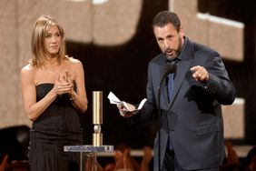 Jennifer Aniston presents Adam Sandler with the People's Icon Award onstage during the 2024 People's Choice Awards held at Barker Hangar on February 18, 2024 in Santa Monica, California.