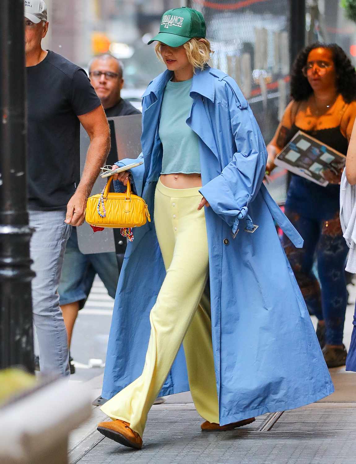 Gigi Hadid covers up in a oversize blue trench coat as leaving a Photo Shoot in New York City,