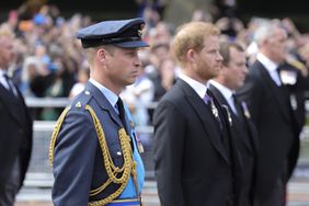 Prince William, Prince of Wales and Prince Harry, Duke of Sussex walk behind the coffin during the procession for the Lying-in State of Queen Elizabeth II