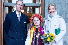 The new Duke and Duchess of Edinburgh, Britain's Prince Edward, Duke of Edinburgh (L) and Britain's Sophie, Duchess of Edinburgh (R) pose for a photograph with Marianna Melnyk, aged 10, from the Ukrainian community at the City Chambers in Edinburgh to mark one year since the city's formal response to the invasion of Ukraine on March 10, 2023. - Britain's King Charles III on Friday awarded his younger brother Edward the title Duke of Edinburgh, in line with the wishes of the late Queen Elizabeth II and her husband Prince Philip.