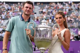 Tommy Paul and Paige Lorenze pose for a photo with the cinch Championships 2024 winners trophy on Day Seven of the cinch Championship at The Queen's Club on June 23, 2024 in London, England. 