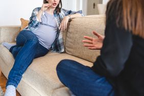 pregnant woman arguing with another woman