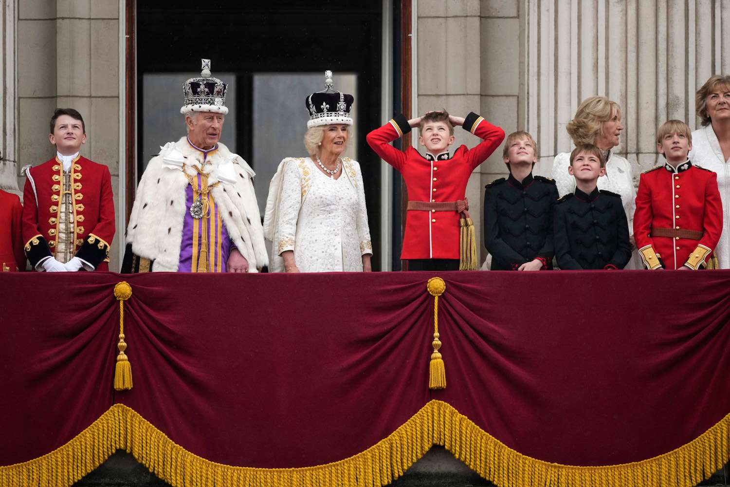 King Charles III, Camilla, Queen Consort, Page Of Honour, Freddy Parker Bowles, Page of Honour, Louis Lopes, Annabel Elliot and Page of Honour, Gus Lopes and Page of Honour, Arthur Elliot gather on the Buckingham Palace central balcony after the Coronation service of King Charles III and Queen Camilla on May 06, 2023