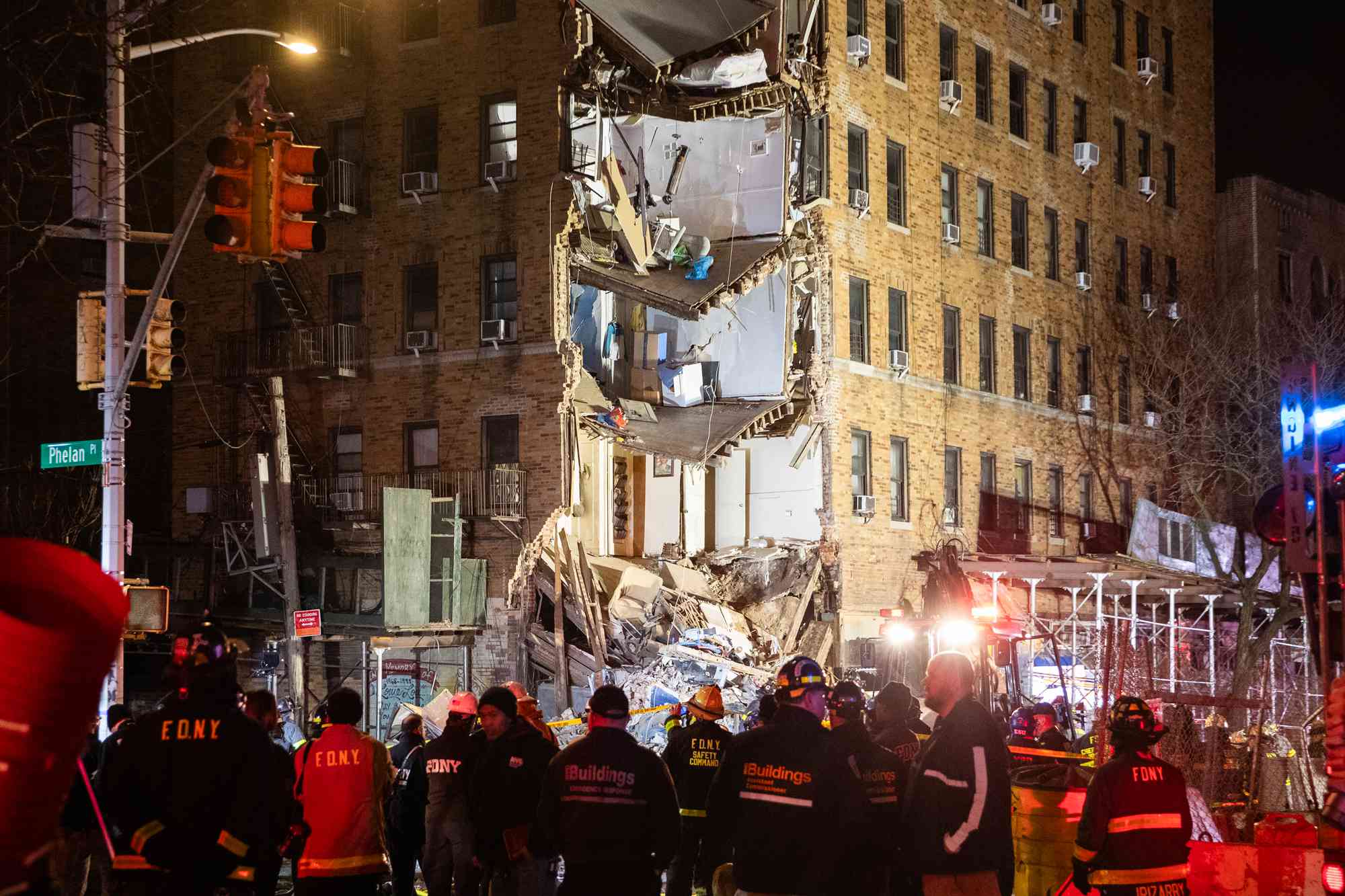 Police and rescuers work at the site of a partially collapsed residential building on December 11, 2023 in New York City. Part of a seven-story residential building in the Bronx collapsed on the afternoon of December 11. 