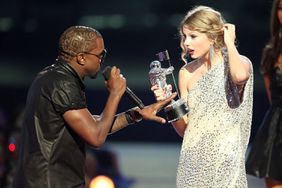 Kanye West (L) jumps onstage after Taylor Swift (C) won the "Best Female Video" award during the 2009 MTV Video Music Awards at Radio City Music Hall on September 13, 2009