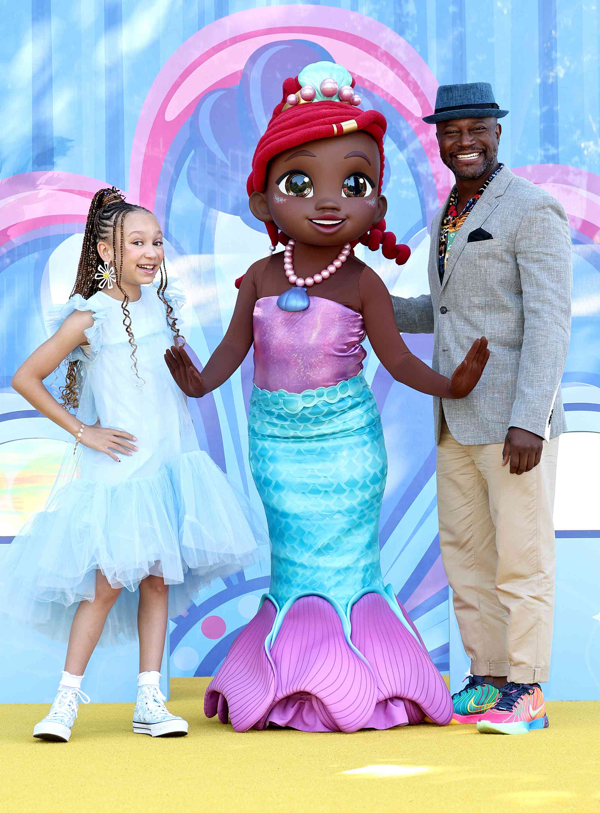 Mykal-Michelle Harris and Taye Diggs pose with Ariel at "Disney Jr.'s Ariel" Premiere Celebration at Battery Park on June 28, 2024 in New York City. 