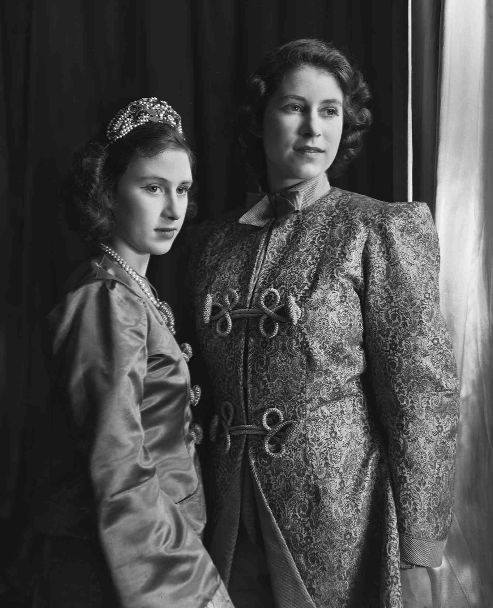 Princess Elizabeth (Queen Elizabeth II) and Princess Margaret (1930-2002), both in costume, pictured ahead of a royal pantomime production of 'Aladdin' at Windsor Castle, Berkshire, Great Britain, 15 December 1943