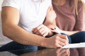 Couple signing documents