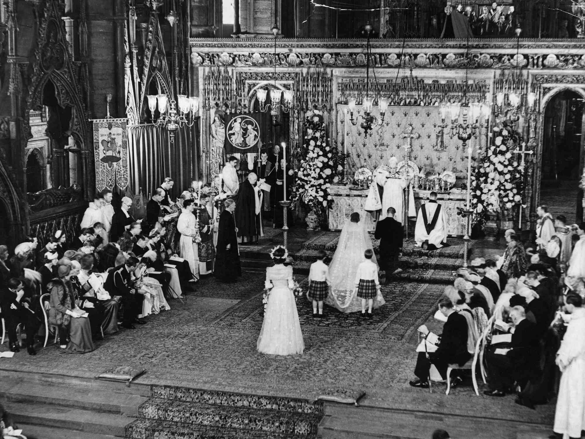 Princess Elizabeth and The Duke Of Edinburgh kneeling in front of the Archbishop of Canterbury during their marriage ceremony in Westminster Abbey