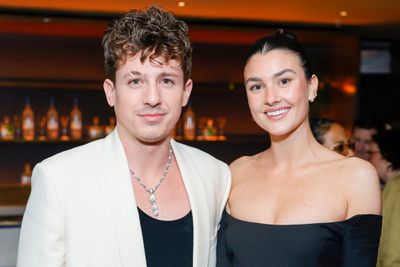 LOS ANGELES, CALIFORNIA - FEBRUARY 04: (L-R) Charlie Puth and Brooke Sansone attend Interscope x Flipper's Roller Boogie Palace celebrating Dr. Dre's 