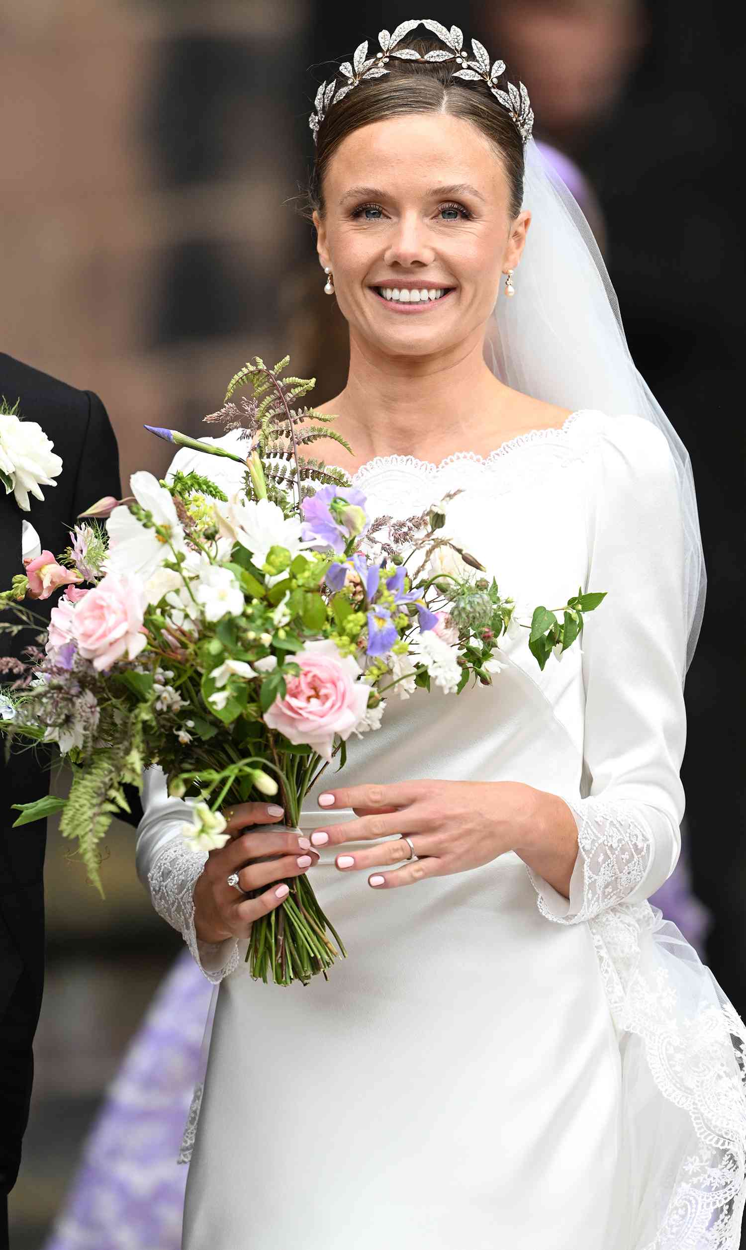 Olivia Grosvenor, Duchess of Westminster waves as she departs her wedding to Hugh Grosvenor, Duke of Westminster at Chester Cathedral 