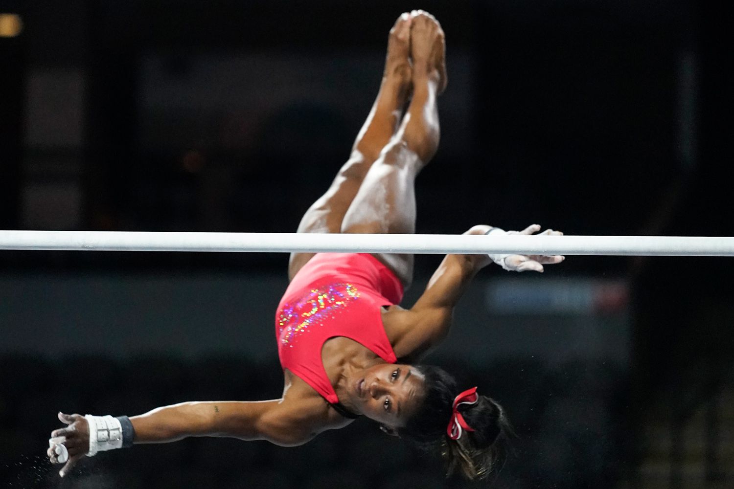 Simone Biles, a seven-time Olympic medalist and the 2016 Olympic champion, practices on the uneven bars at the U.S. Classic gymnastics competition