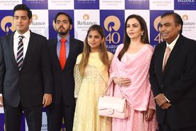 Mukesh Ambani and Nita Ambani pose with their children Akash Ambani, Anant Ambani and Isha Ambani as they arrive for Reliance Industries' 40th AGM in Mumbai on July 21, 2017.