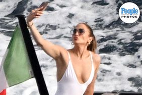 Jennifer Lopez looks stunning rocking a white swimsuit as she's pictured enjoying the Italian sunshine during her holidays with friends!