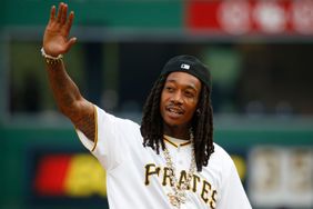 Wiz Khalifa waves to the crowd before the game between the Cleveland Guardians and the Pittsburgh Pirates