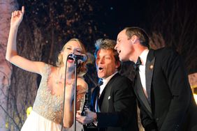 Britain's Prince William, Duke of Cambridge, sings with US musician's Taylor Swift and Jon Bon Jovi at the Centrepoint Gala Dinner at Kensington Palace in London, on November 26, 2013
