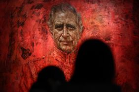 Visitors look at the new official portrait of King Charles III, painted by British artist Jonathan Yeo, displayed at the Philip Mould gallery, on Pall Mall, central London, on May 16, 2024 following its official unveiling two days ago at Buckingham Palace