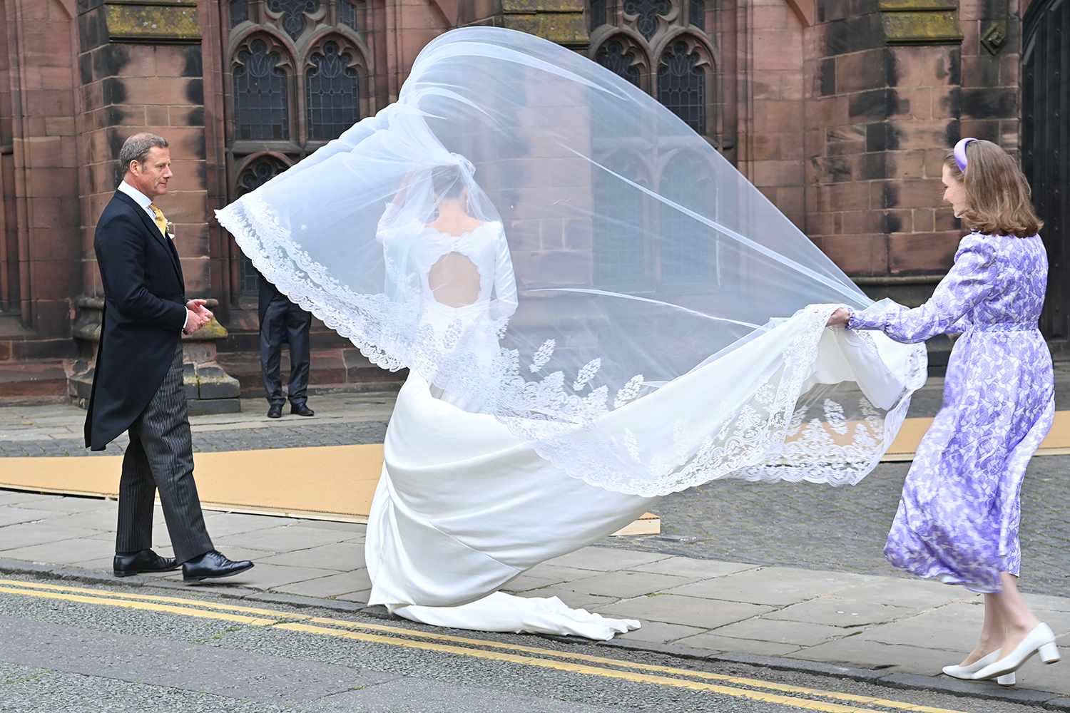 Olivia Henson (C) arrives at her wedding to Hugh Grosvenor, 7th Duke of Westminster, at Chester Cathedral