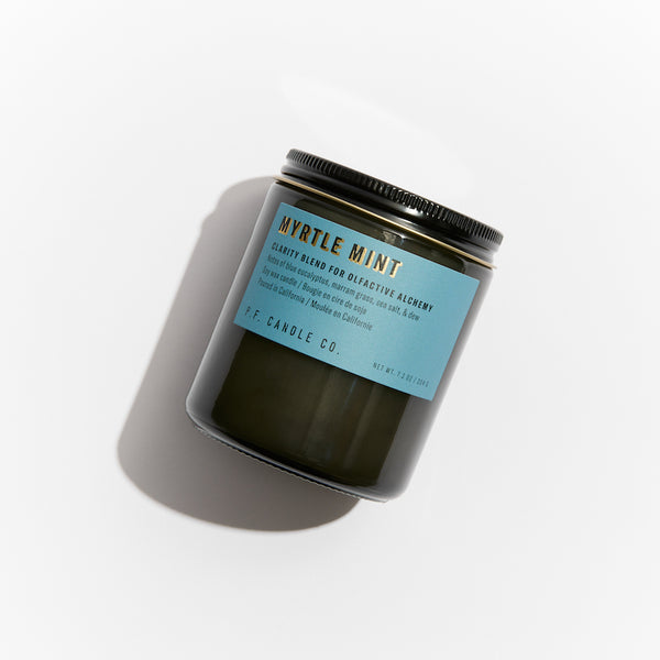 P.F. Candle Co. Myrtle Mint Alchemy Candle - Product - Alchemy Candles feature smoke-colored glass vessels, black metal lids, and gold-leafed labels inspired by vintage window lettering.