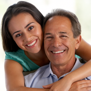 Two happy people embracing each other with big smiles on their faces