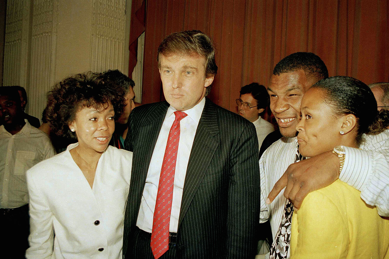 Heavyweight champion Mike Tyson puts an arm around his wife Robin...