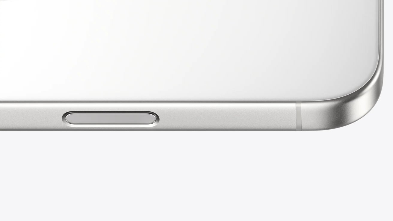 Close-up of a light-colored smartphone's side, featuring a metallic button embedded in the middle.