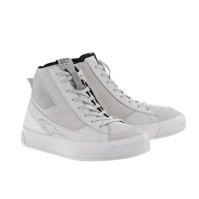 The Stella Stated Podium Shoes by Alpinestars EU are white high-top sneakers crafted for an urban riding environment. They feature lace-up fronts, textured sides, and slightly raised rubber soles. Designed for a women’s fit, these shoes have a subtle logo on the outer surface and appear brand new against a plain black background.