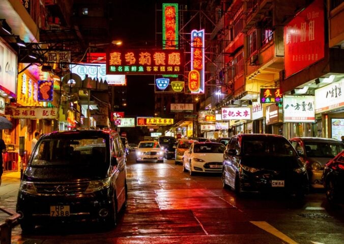 A brightly-lit Hong Kong street at night