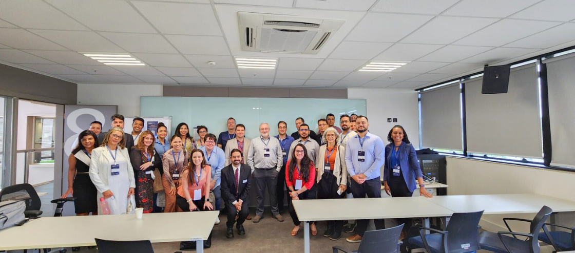 Participantes de workshop posam para foto em sala