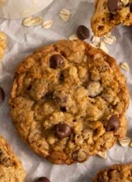 An Oatmeal Chocolate Chip cookie next to a glass of milk