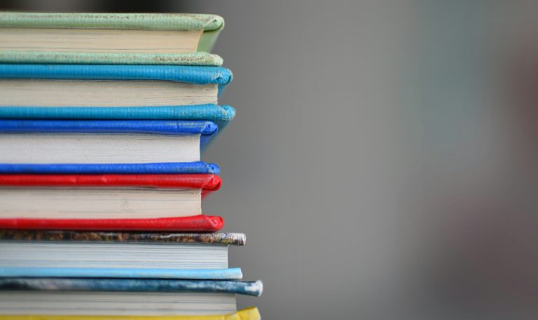 a colourful vertical stack of seven books