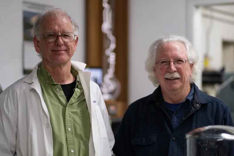 George Chittenden and Tom Adams, co-founders and now employee-owners, smiling at camera in their workshop