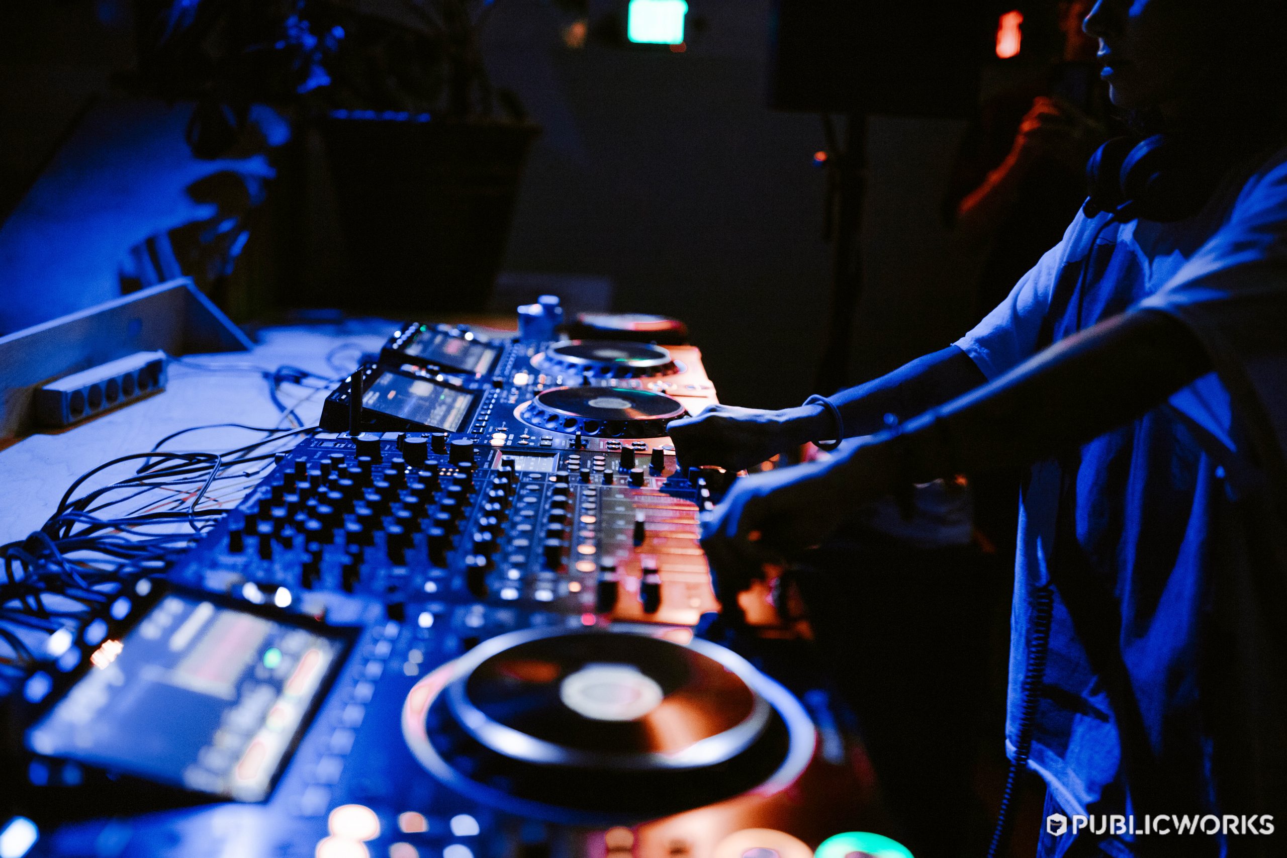 Close up shot of the CDJs and Mixer while an artist performs.