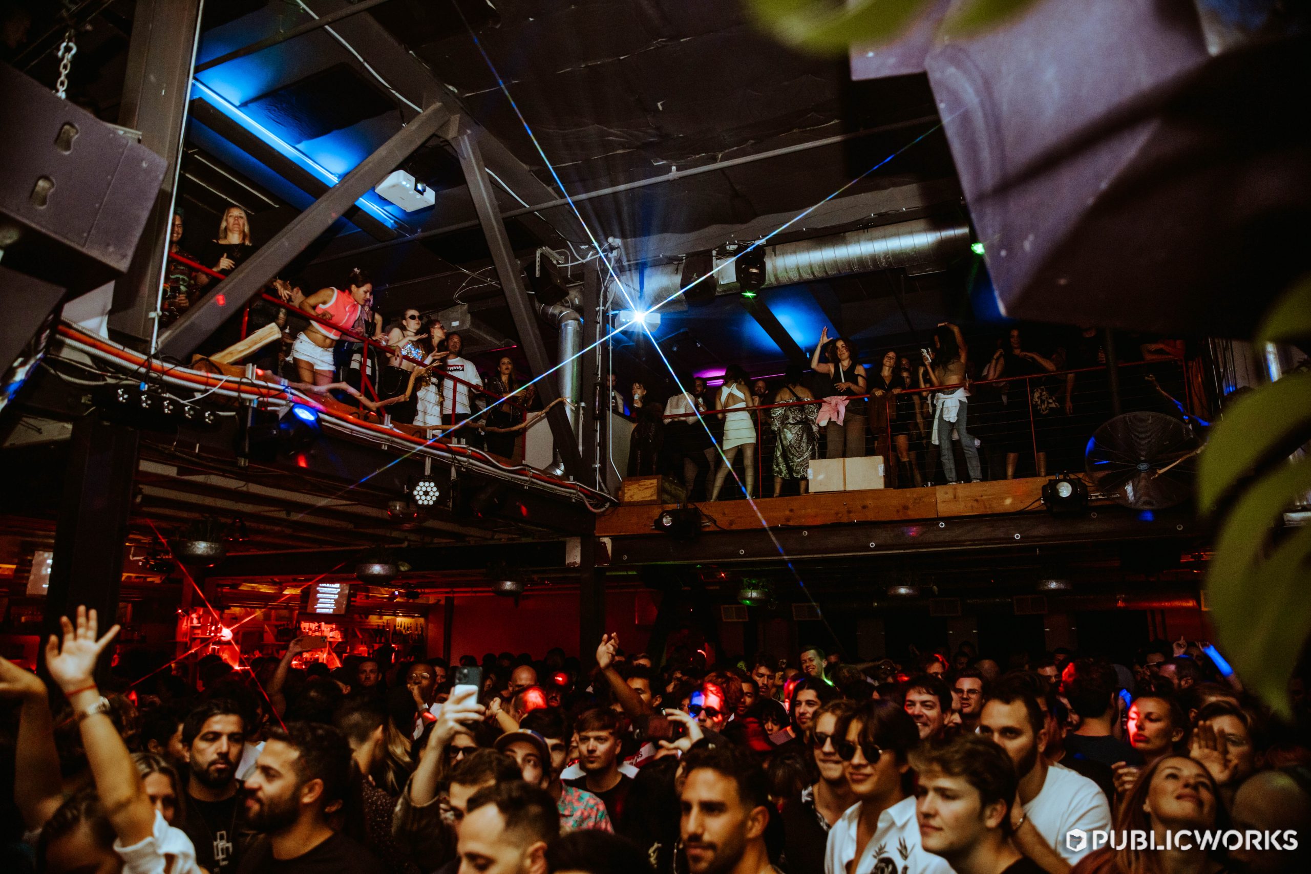 View from the DJ booth of a happy and smiling crowd.