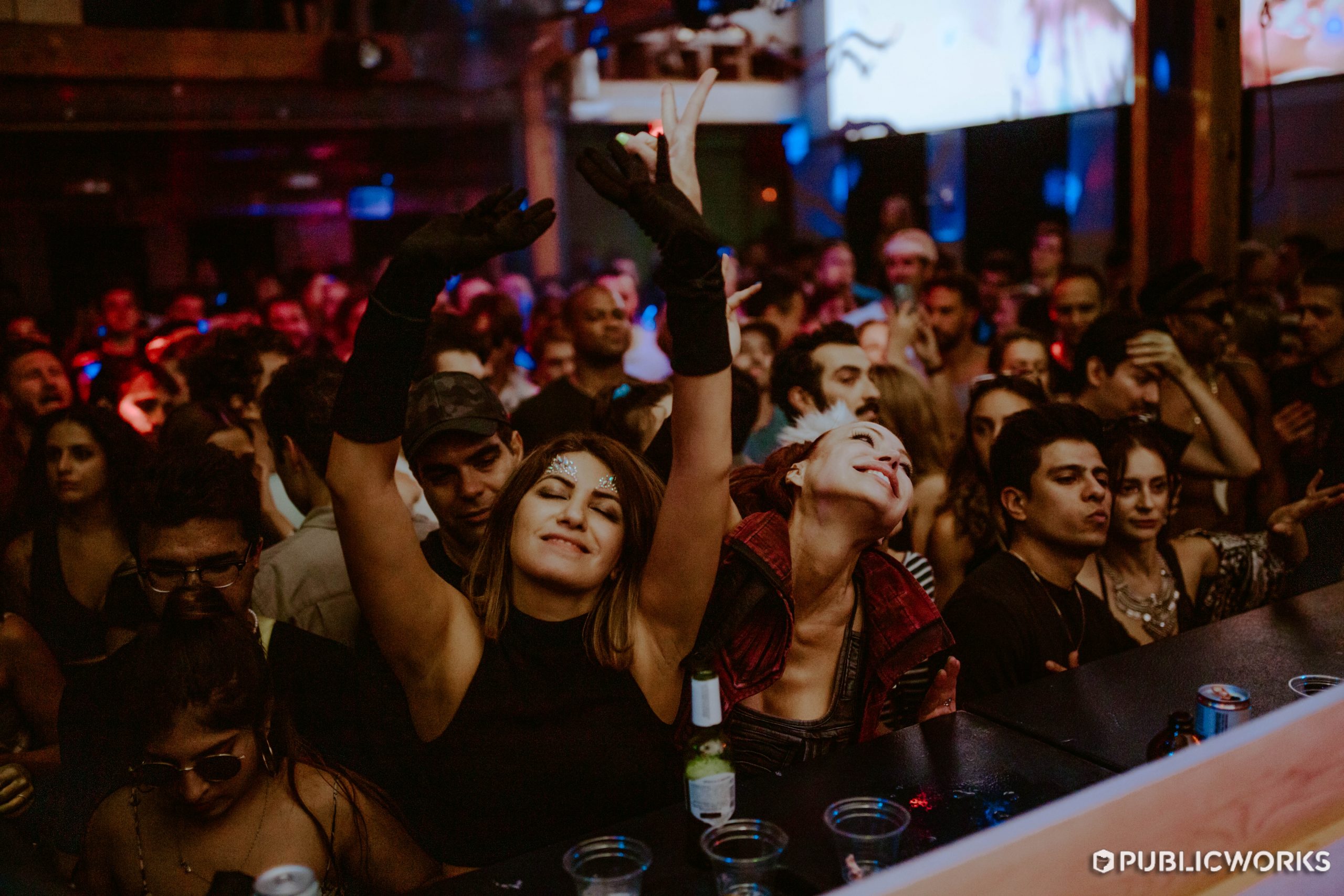 Shot of the crowd in the Main Room with their hands in the air.