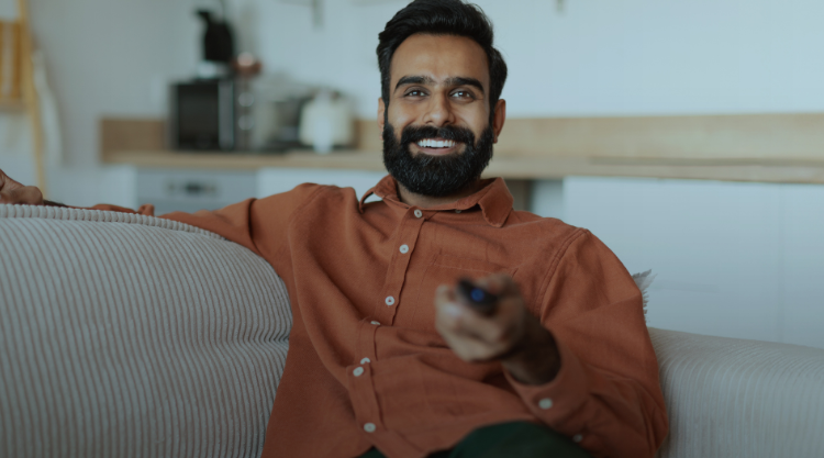 Man at home relaxing while watching television