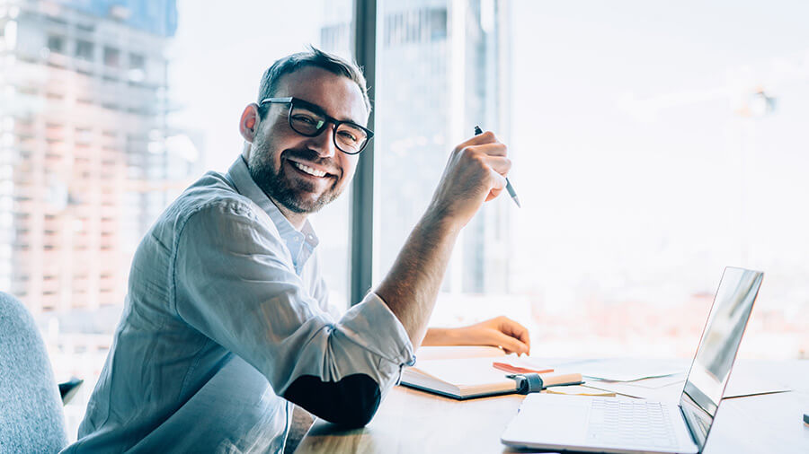 Accountant on laptop smiling