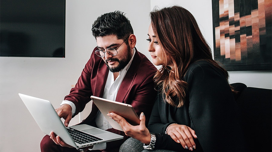 Latin couple using laptop at office in Mexico or Latin America people Business concept